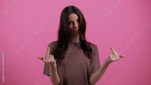 Young woman showing middle finger, gesture of fuck off. Young girl shows a gesture of fuck. Expression negative, aggression, provocation. Emotions. People. Lifestyle. High quality 4k footage photo