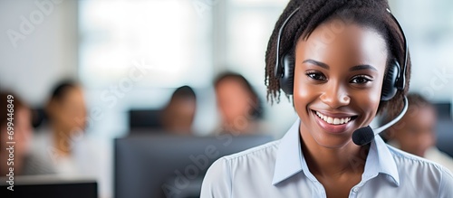 A Black woman manages call center training and employees, providing online customer support and telemarketing services. She is also a CRM consultant who assists with contact us internet FAQs at her photo