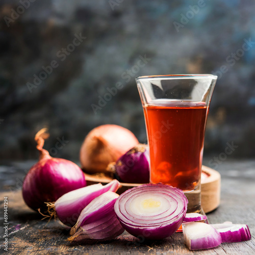 medicinal onion juice/syrup in a glass with raw onions. selective focus photo