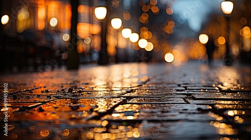 Wet paving stones of a street after it rained at night, with bokeh lights and reflection