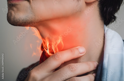 Flame at neck of a man. Concept of sore throat, pharyngitis, laryngitis, thyroiditis, choking photo