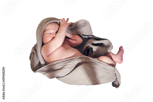 A newborn baby sleeps in a crib with a cocoon and a blanket in the form of a turban on his head, isolated on a white background. Kid age 0 months photo