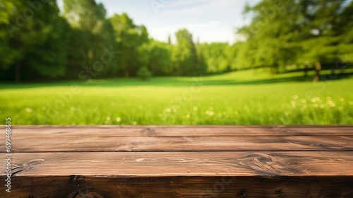 Empty wooden table on a background of green grass real photo