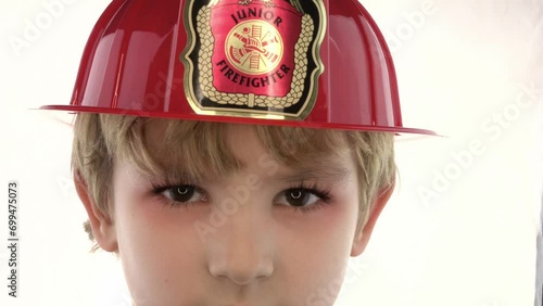 Junior fire fighter in isolated background photo