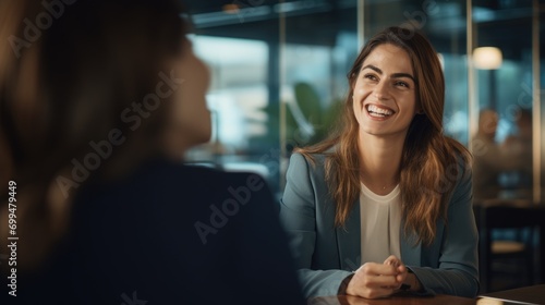 Happy business woman talking to her colleague in a meeting