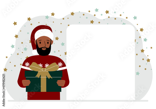 A man in a red sweater is holding a large gift box with a bow. New Year or Christmas.