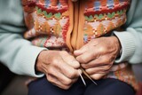 hands darning a woolen sweater