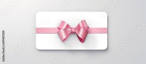 Blank white gift card with ribbon bow isolated on grey background