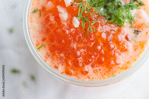 Red caviar with sour cream, dill and onion - the finnish recipe for a holiday food, flat lay on the white table in minimalistic style with copy space photo