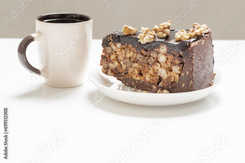 cup of coffee and piece of cake on white table