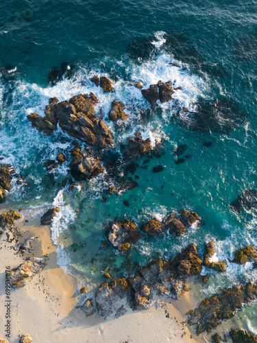 Aerial view of rocky beach shore.