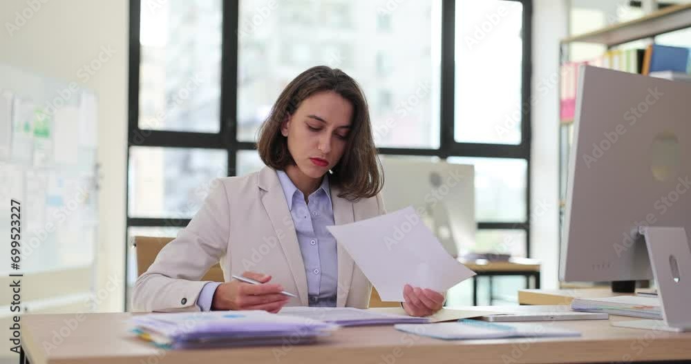 Businesswoman examining paper documents and signing 4k movie slow motion Businesswoman examining paper documents and signing 4k movie slow motion