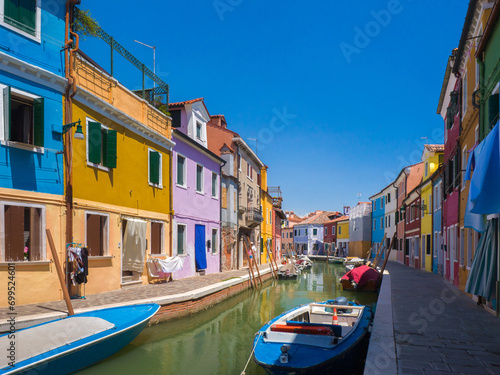Channel in town surrounded by colourful buildings (Burano, Italy)