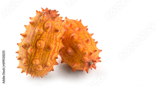Kiwano fruit or Horned melon close up. Fresh and juicy African horned cucumber or jelly melon, hedged gourd liana whole exotic fruits closeup, isolated on white background