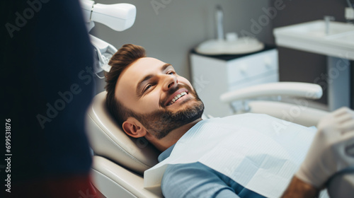 Handsome Man Receiving Dental Care in Clinic, Orthodontic Chair View