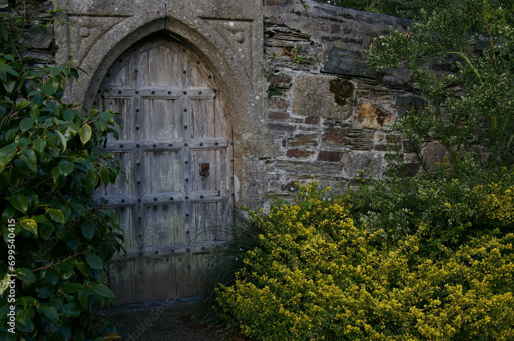 old wooden gate in stone wall