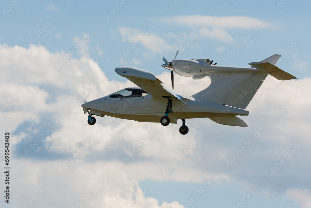 Small aircraft soaring through clear blue skies.