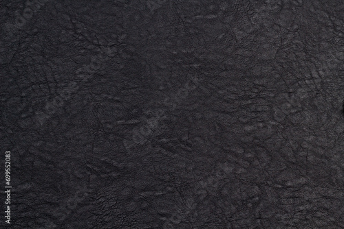 Black leather texture. Black skin background close-up in your project.