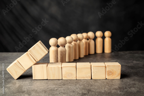 A wooden figure and a row of wooden cubes
