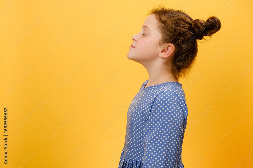 Profile side view of happy preteen girl do deep breath enjoy fresh air or dreaming fill with energy feeling healthy good concept, posing isolated over plain yellow studio background with copy space - obrazy, fototapety, plakaty 
