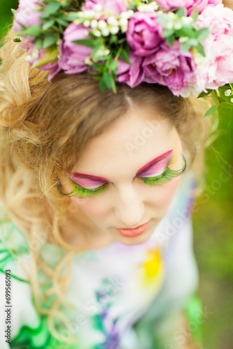 Woman with tulips, lily of the valley and pink peony in her hair