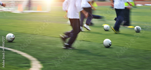 Low section of young boys playing soccer game with blurred motion © xy