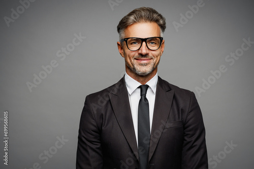 Adult confident attractive happy fun employee business man corporate lawyer he wearing classic formal black suit shirt tie work in office look camera isolated on plain grey background studio portrait.