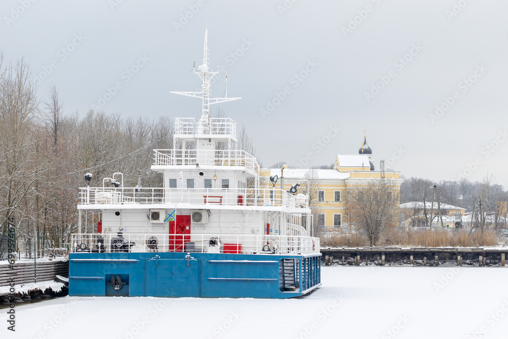 Blue white vessel is moored in winter port