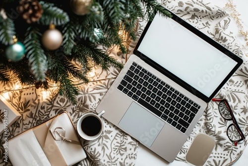 a laptop computer sitting on top of a table next to a christmas tree