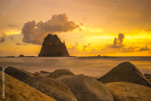 Sunset at the rocky beach in Papuma, Jember, East Java, Indonesia photo