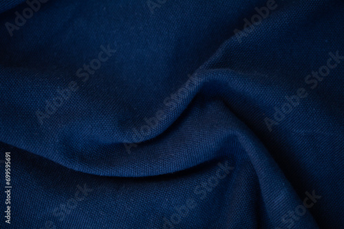 dark blue - abstract fabric background with soft waves.