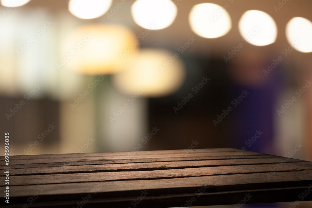 empty table to display your product, against blurred golden bokeh background of cafe