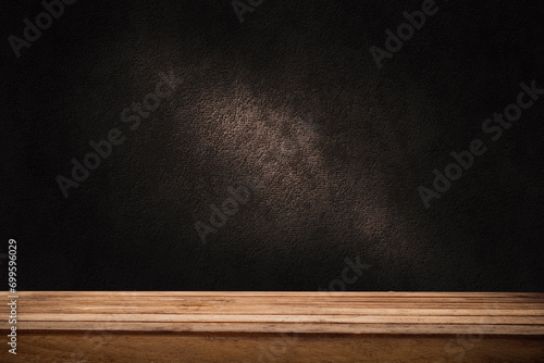 image of a wooden table on an abstract dark background with a light in the center