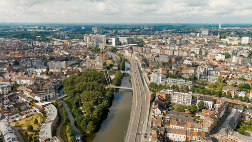 Ghent, Belgium. Keizerpark - City park. Esco (Scheldt) river embankment. Panorama of the city from the air. Cloudy weather, summer day, Aerial View