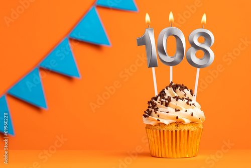 Candle number 108 - Cake birthday in orange background