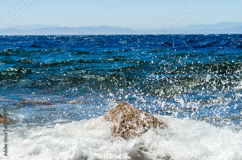 waves and splashes of sea surf and stones on the seashore in Egypt Dahab South Sinai