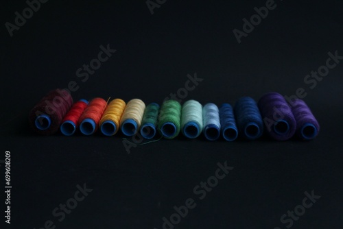 Rows of skeins of thread in various colors for sewing machines and general household use  sold in specialty stores.