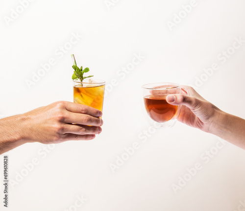 Tho hands holding cups of tea 