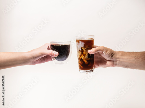 Two hands holing hot coffee and iced coffee photo