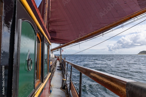 Old Dutch flat bottomed ship sailing under sails on the Baltic Sea