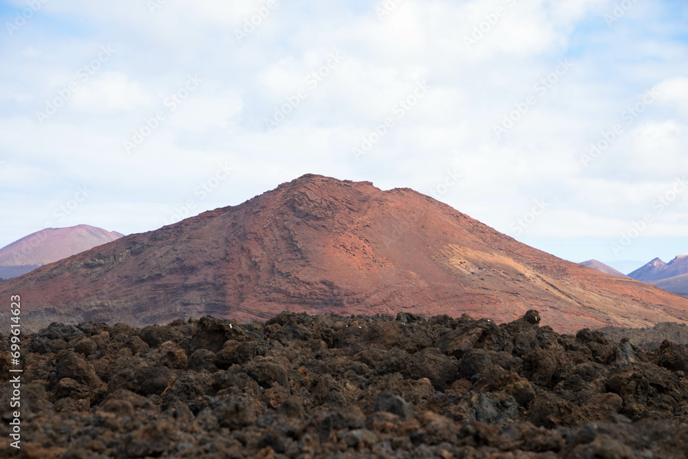 Spectacular view of the volcanic landscape in Timanfaya National Park. Lanzarote, Canary Islands, Spain, Atlantic, Europe. Tourism and vacations concept.