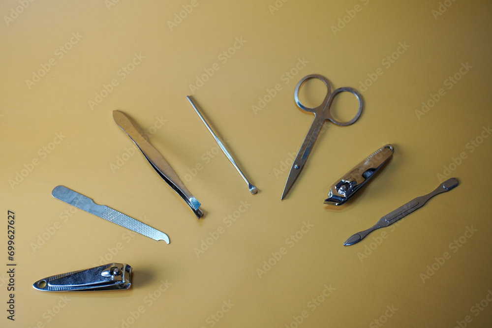 manicure accessories scissors, nail clippers, hair removers, nail file, tweezers a body care tools for healthy and hygiene on a table, top view manicure accessories scissors, nail clippers, hair removers, nail file, tweezers a body care tools for healthy and hygiene on a table, top view