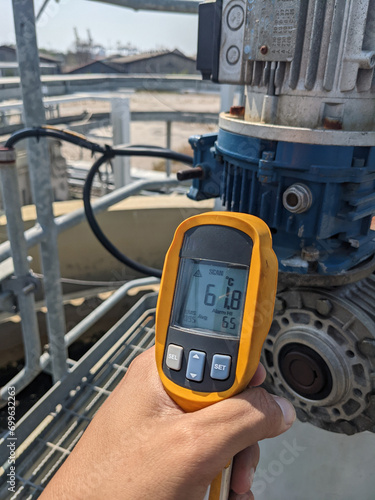 Check temperature of body motor agitator of sludge clarifier The photo is suitable to use for industry background photography, power plant poster and maintenance content media. photo