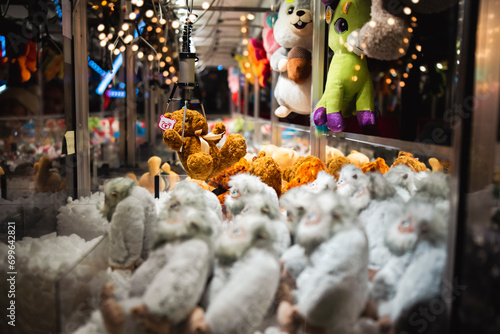 Claw Machines Toy Arcade game catched stuffed animal toy on night fair carnival. Entertainment for children in the amusement park photo