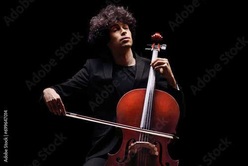 Young male artist playing a cello photo