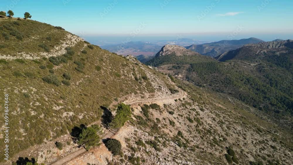 Woman cyclist riding fast downhill on road bicycle. Healthy road cycling hobby, exploring world travels by bicycle. Cycling workout training activity. Active lifestyle in Spain. Woman cyclist riding fast downhill on road bicycle. Healthy road cycling hobby, exploring world travels by bicycle. Cycling workout training activity. Active lifestyle in Spain.