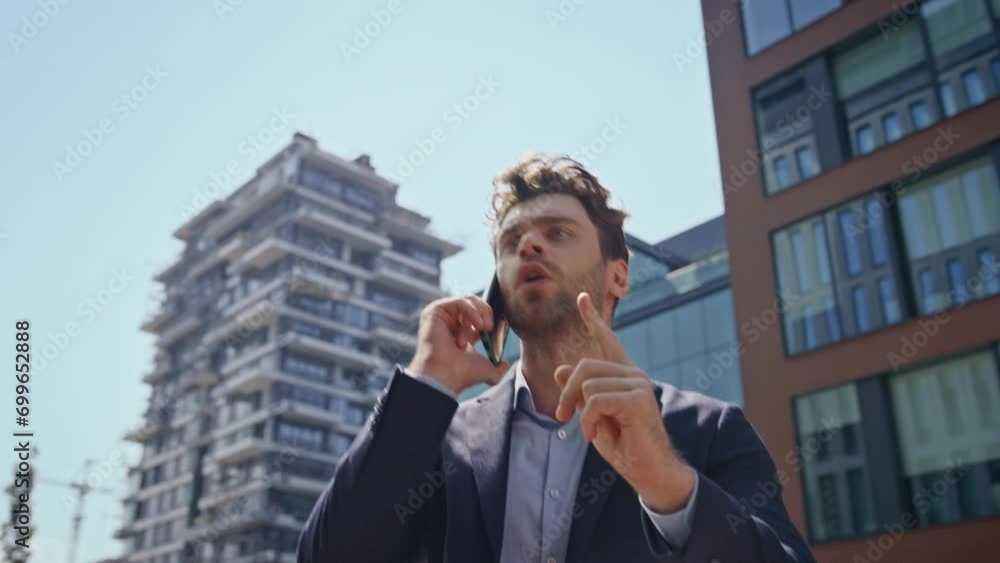 Angry man quarrelling cellphone walking downtown close up. Manager shouting call Angry man quarrelling cellphone walking downtown close up. Manager shouting call