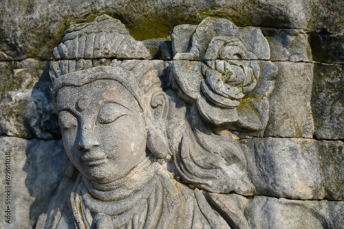 stone statue. stone art girl with stone flower above her head, art concept © ibragimova