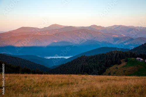 A gorgeous landscape of wooded slopes and distant mountain ranges. Carpathian mountains, Ukraine, Europe.