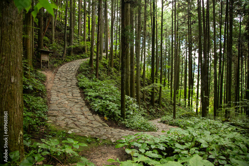 Walking the cobblestone road following the Nakasendo trail between Tsumago and Magome in Kiso Valley, Japan.